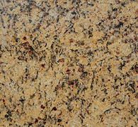 Close-up of granite countertop with a speckled pattern in shades of gold, brown, and black.
