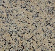 Tan and black granite countertop with mottled patterns.