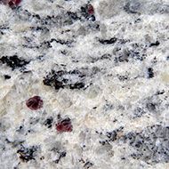 Granite with white, black, and red mineral inclusions.