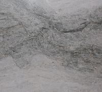 Gray marble surface with flowing patterns and natural textures.