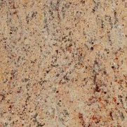 Beige granite countertop with speckled patterns of brown and red.