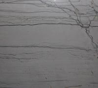 White stone surface with horizontal lines and dark crack pattern.