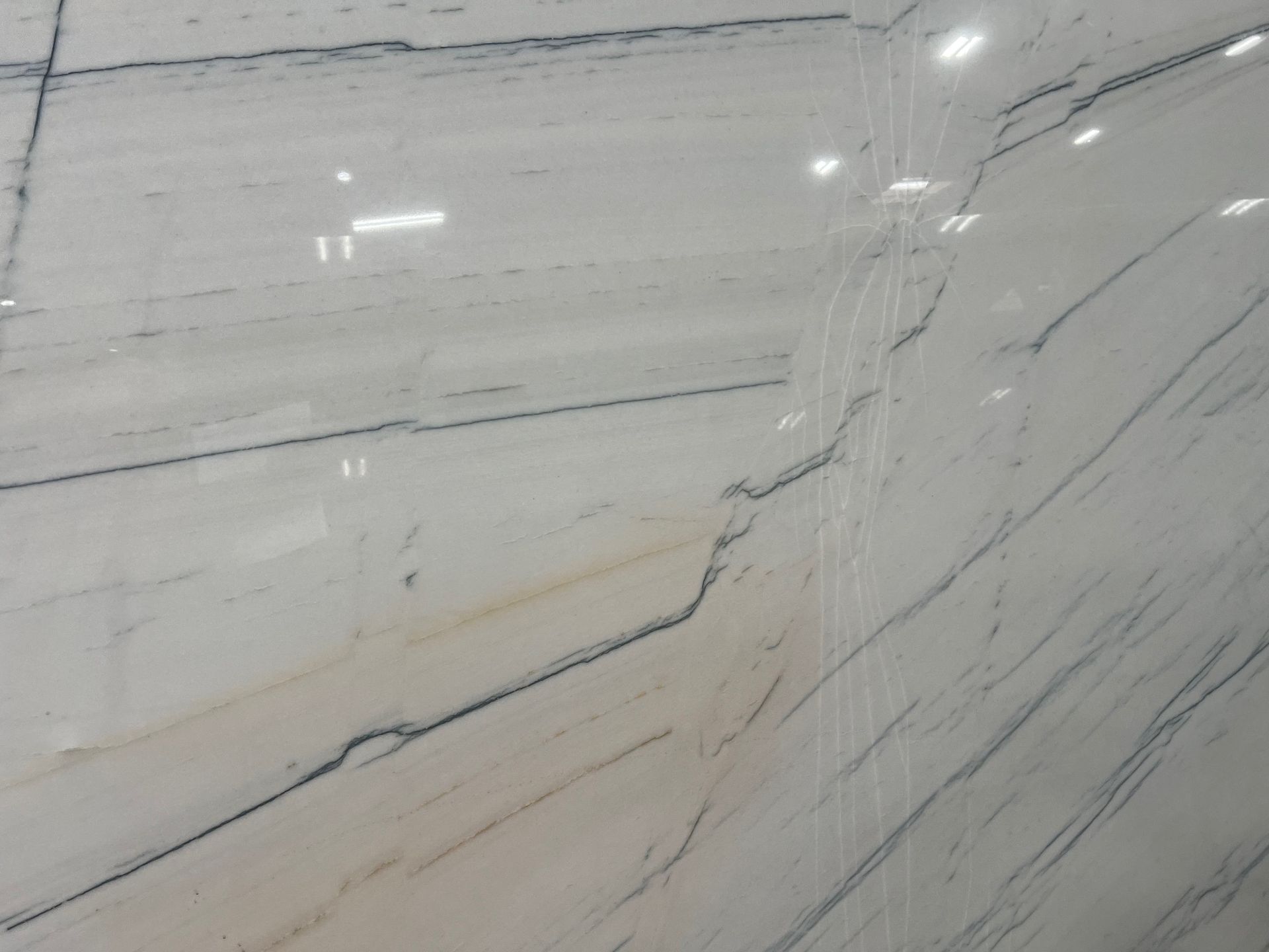 A close up of a white marble wall with black stripes