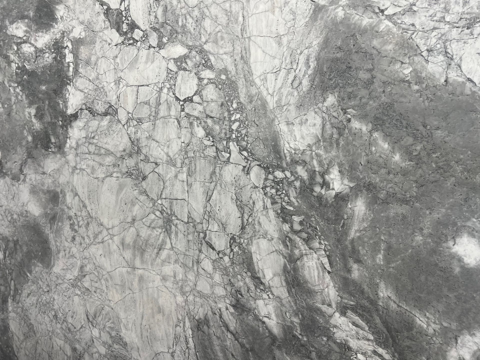 Gray and white marble with veining and textured patterns.
