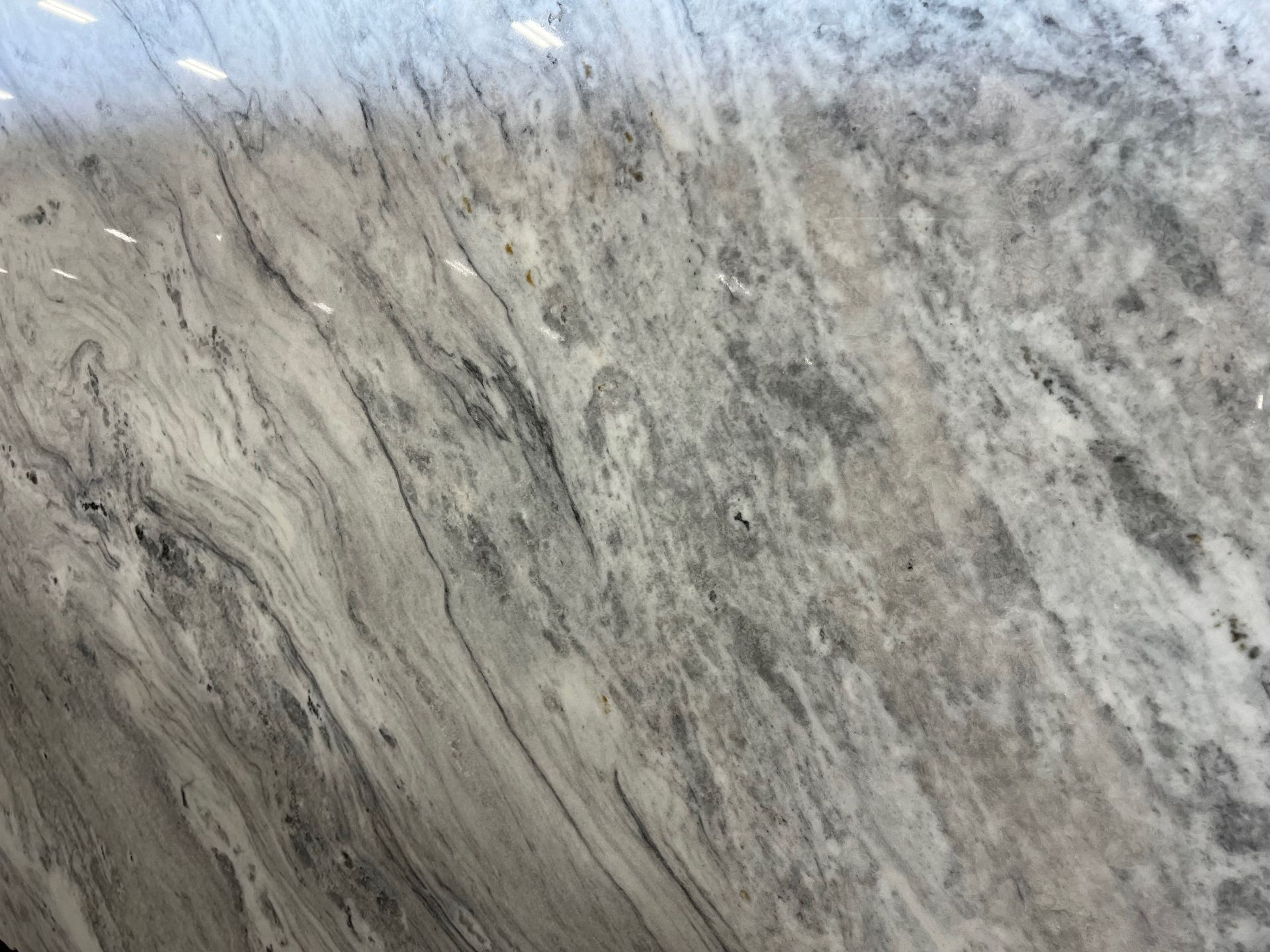 A close up of a marble counter top with a gray and white marble texture