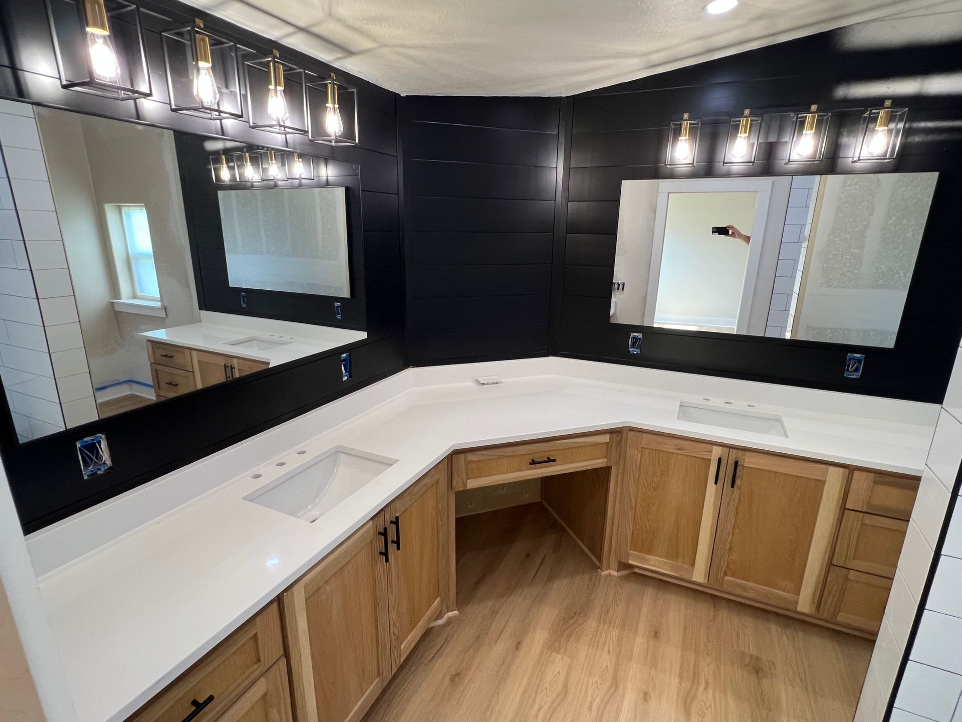 A bathroom with two sinks and two mirrors