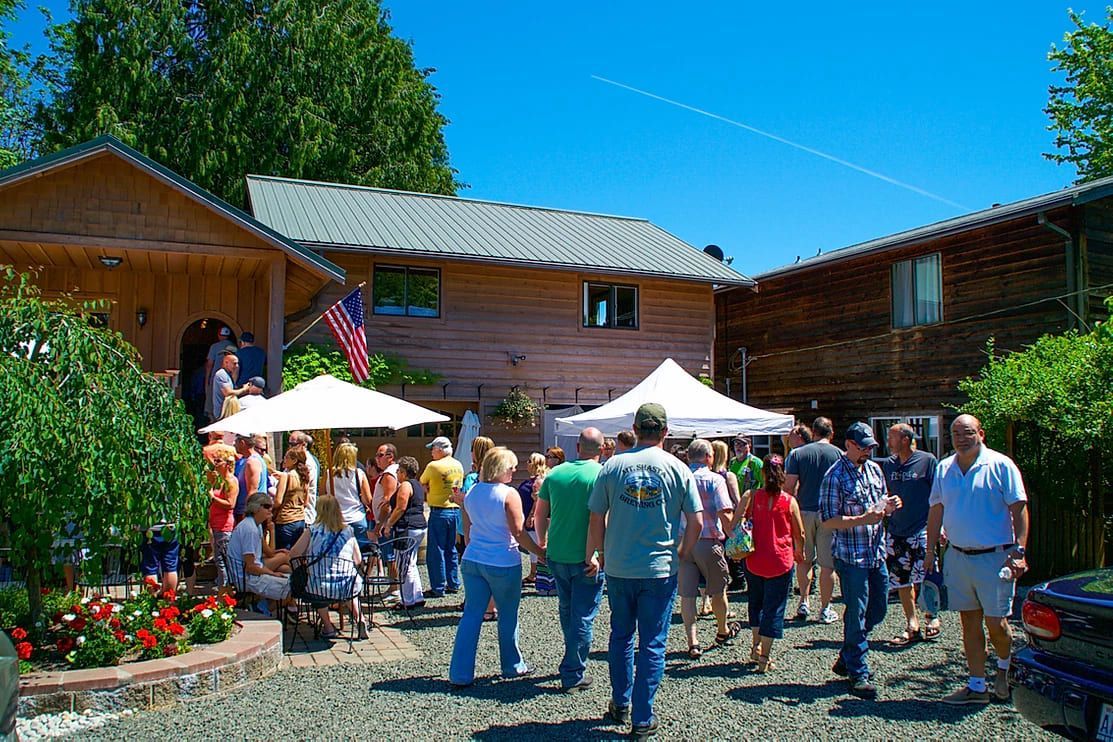 A group of people are standing in front of a house.