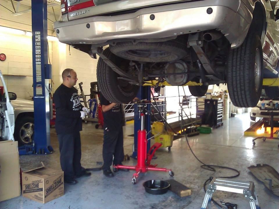 Vehicle Lift Inspection Inside Auto Repair Shop | New Dimensions Automotive