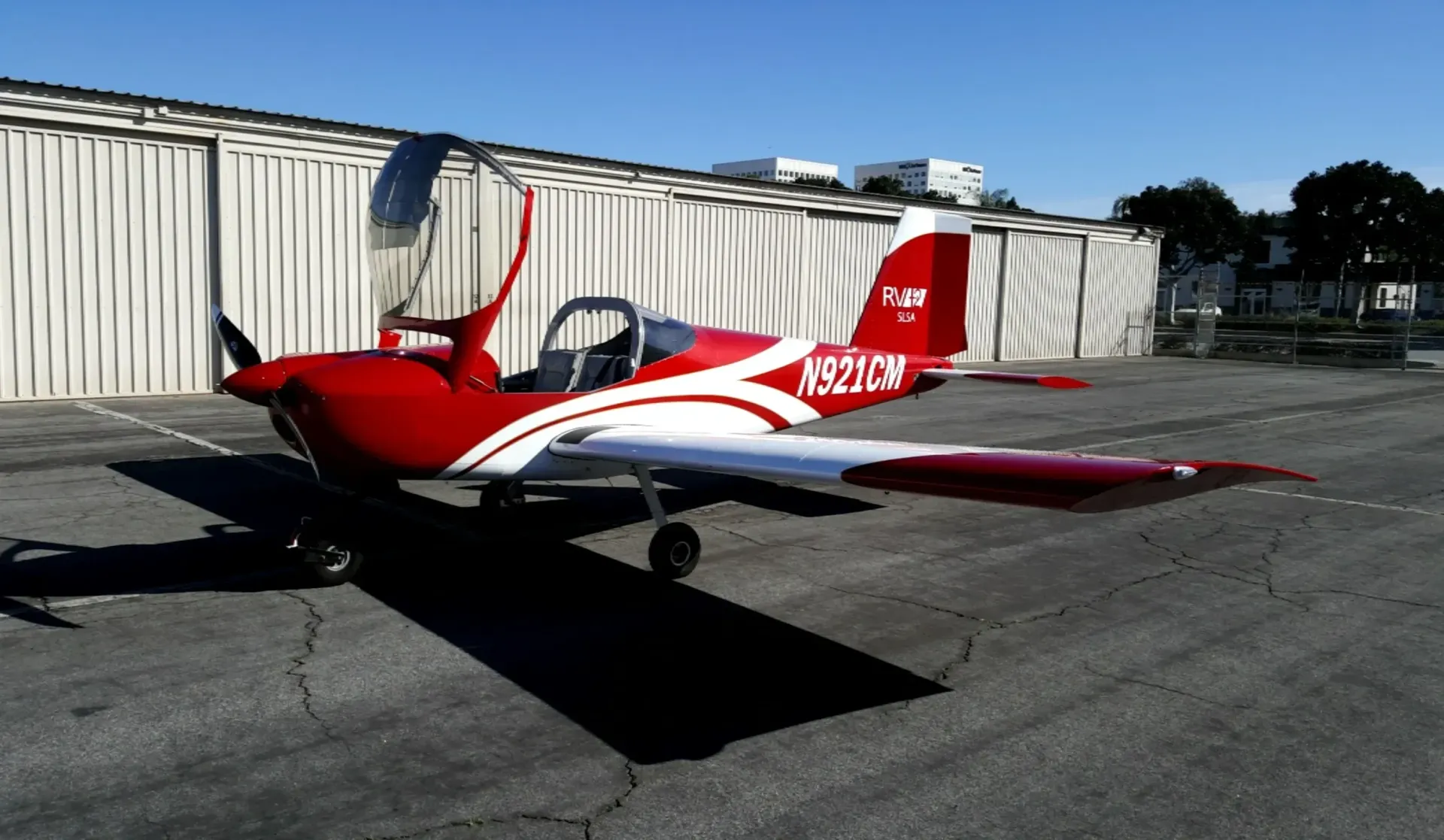A person is holding a pineapple in a bag in a grocery store.
