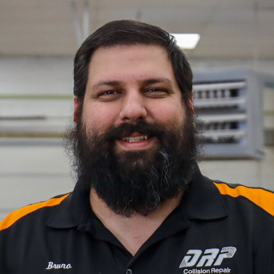 A man with a beard is wearing a shirt that says daf collision repair