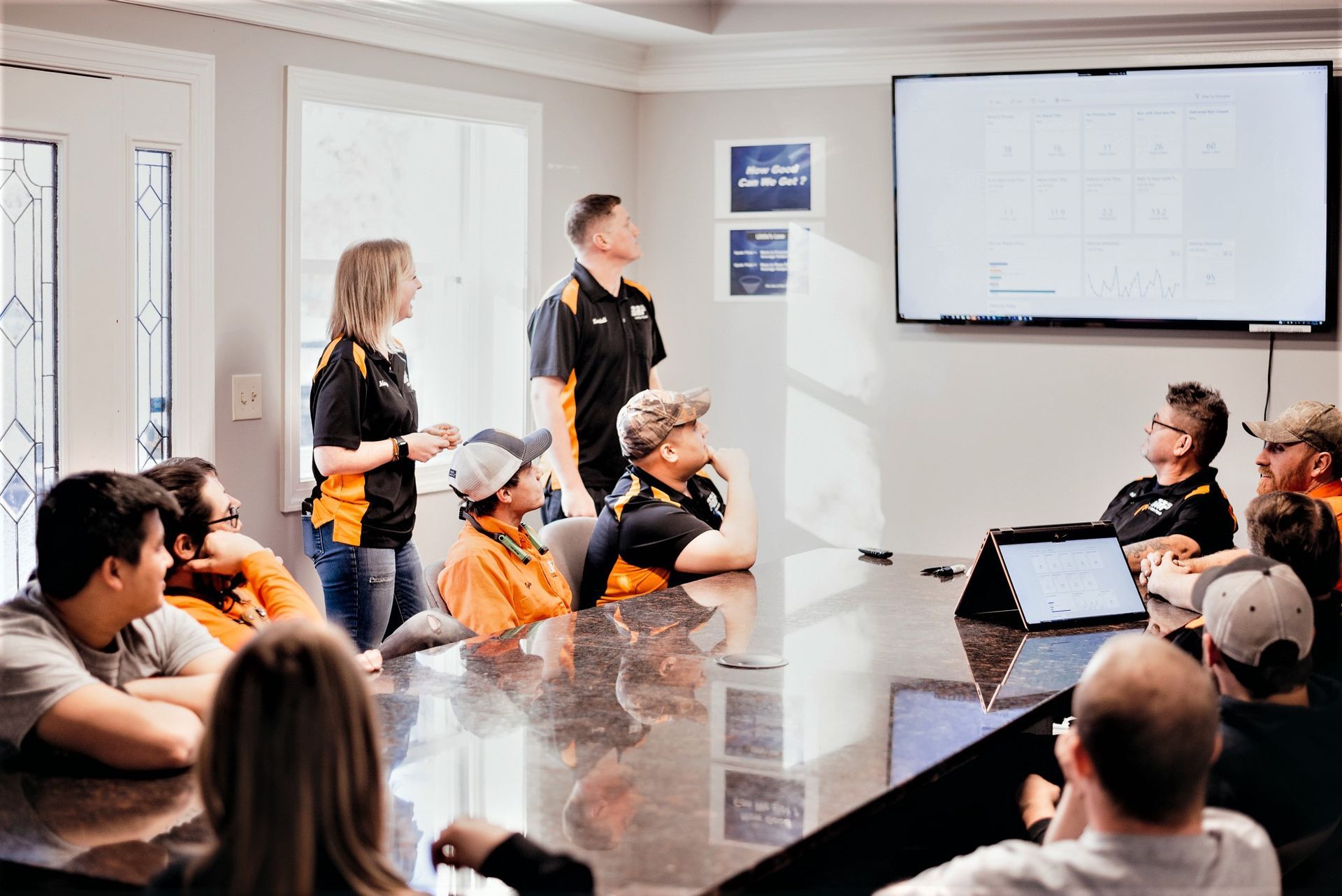 A group of people are sitting around a table in a conference room.