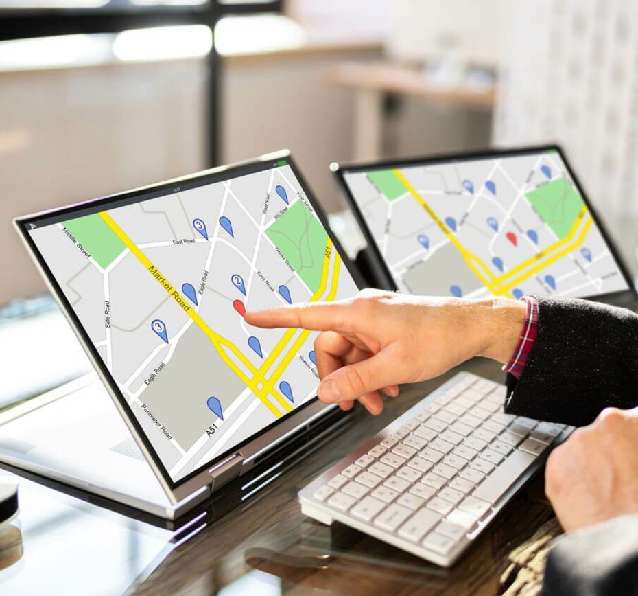 A person is pointing at a map on a laptop screen to see their online presence.