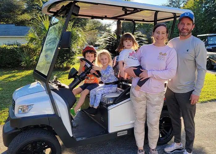 Happy Family standing near a golf cart | Midwest Truck and Tire