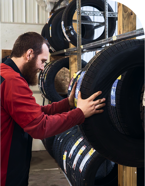 Mechanic holding a tire | Midwest Truck and Tire