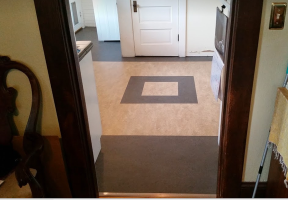 A kitchen with a square pattern on the floor