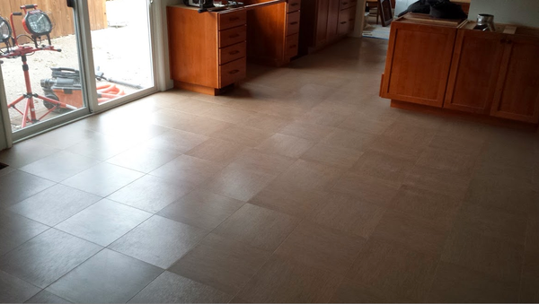A room with a tiled floor and a sliding glass door.