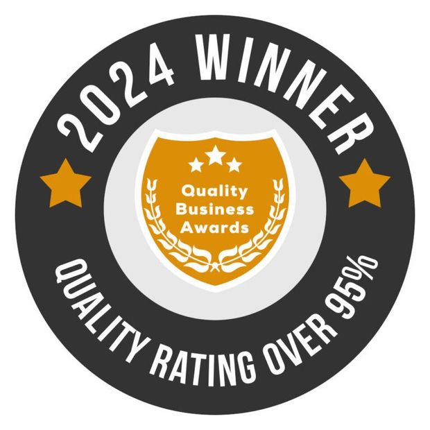 2024 Quality Business Awards winner badge. Black and gold circular design with text and a shield graphic.