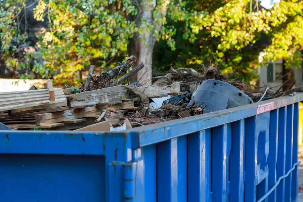 A Blue Skip Bin Full of Wooden Pallets  — Select Site Solutions in Berry, NSW