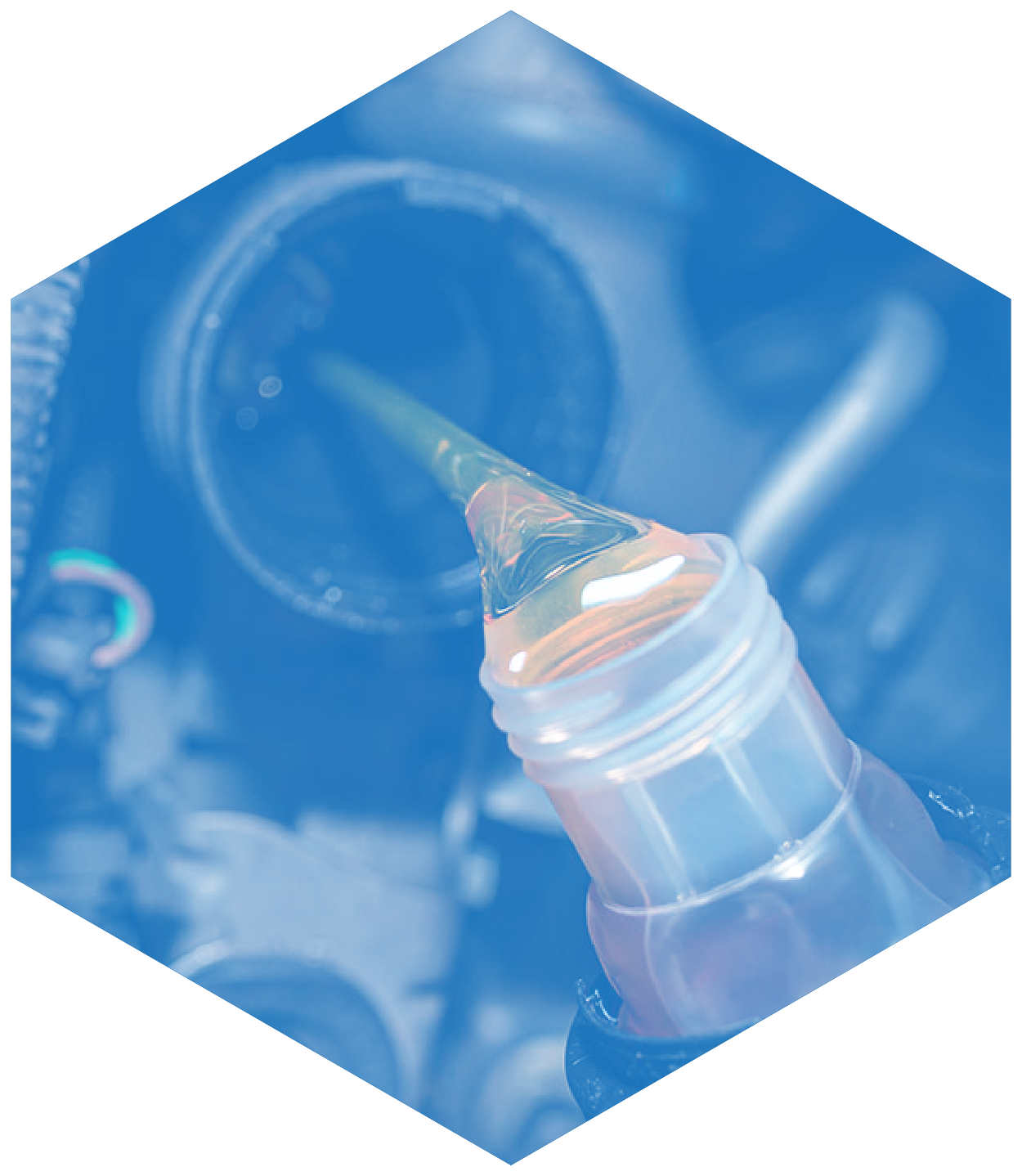 Pouring oil into a car engine with a clear container; blue-toned.
