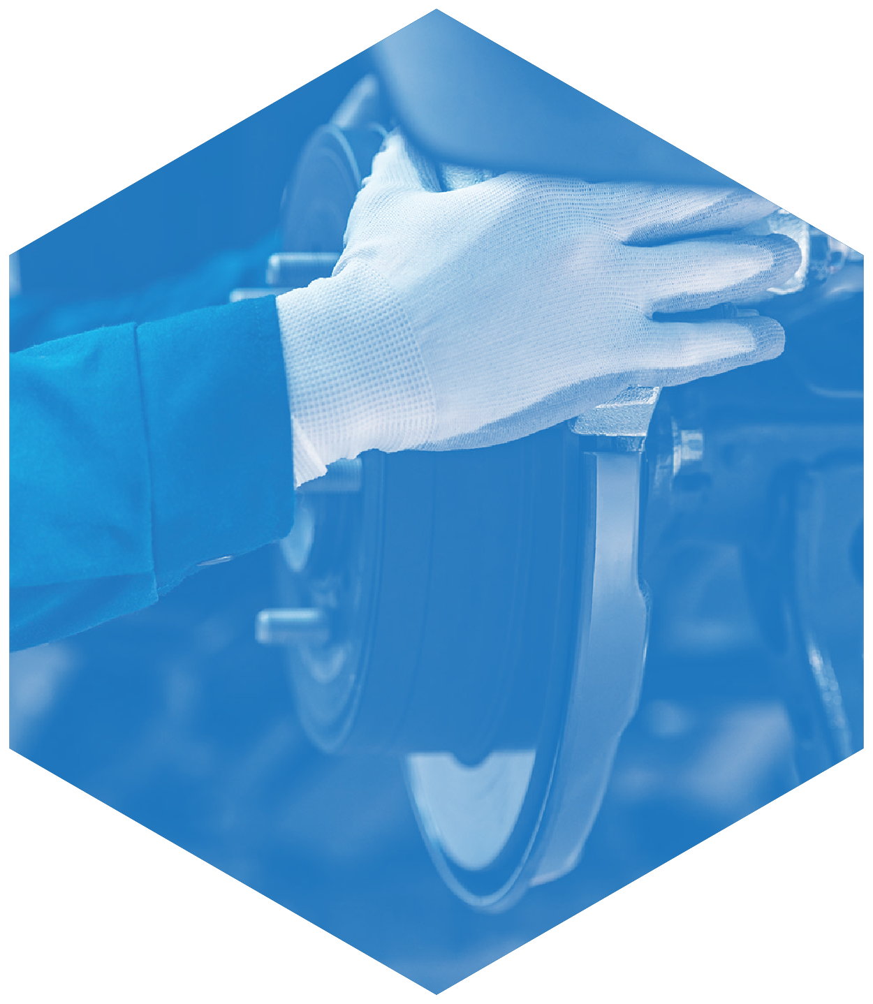 Mechanic's gloved hand working on car brakes. Blue-toned image, industrial setting.