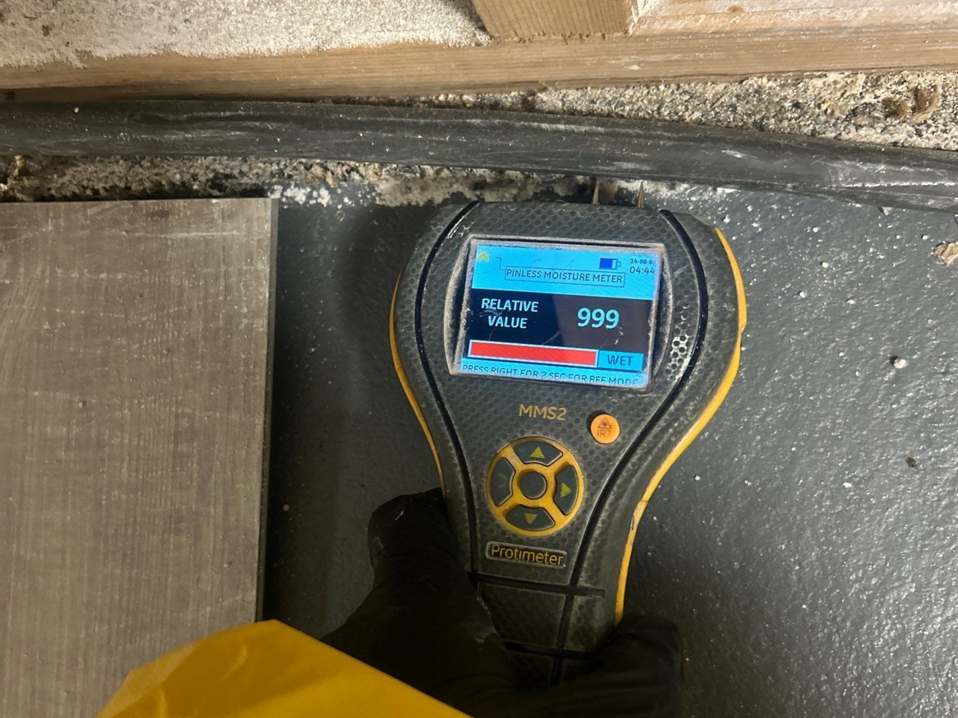 Sewage back up at home in Eastport, NY. Technician taking moisture readings in basement.