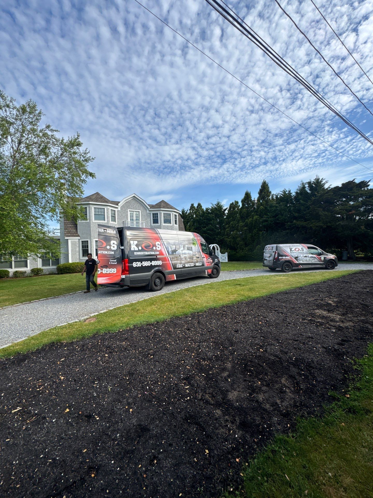 K.O.S. Restoration technician performing sewage cleanup in a Westhampton Beach crawlspace