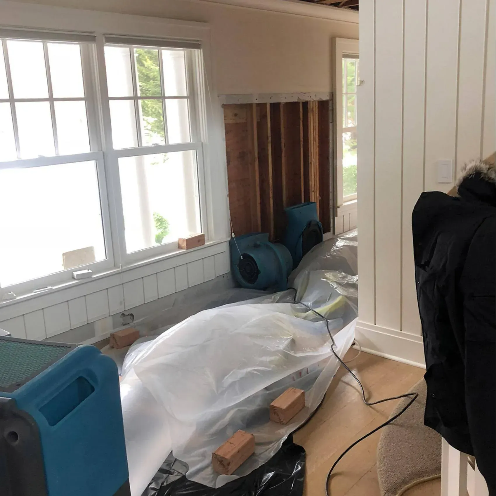 A person is standing in a room that is being remodeled