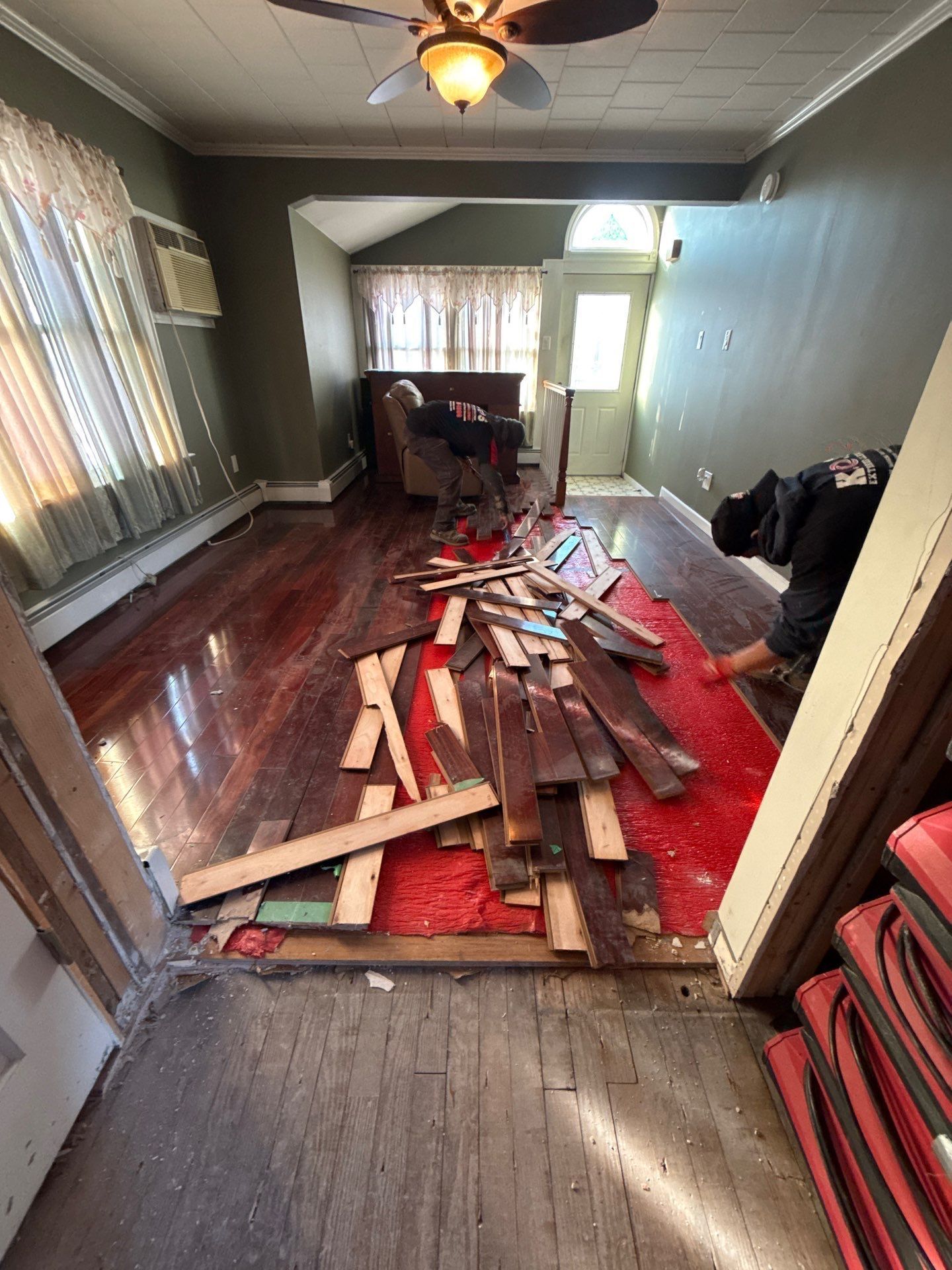 Removing water damaged wood flooring at a home  in Patchogue NY