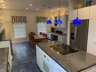 A kitchen with a stove top oven and a refrigerator