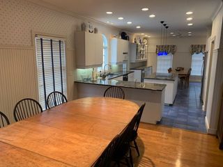 A kitchen with a table and chairs in it
