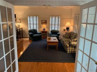 A living room with a couch and two chairs