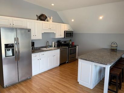 A kitchen with stainless steel appliances and granite counter tops