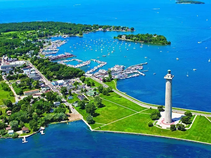 An aerial view of a lighthouse in the middle of a body of water.