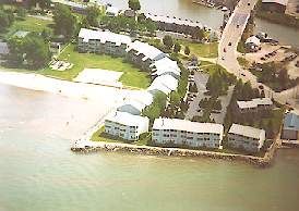 An aerial view of a residential area next to a body of water.