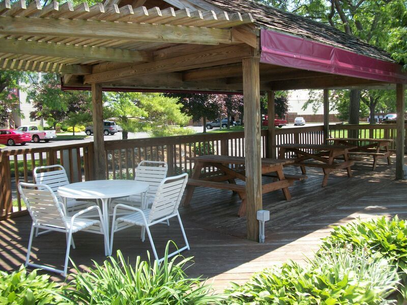 A gazebo with a table and chairs underneath it