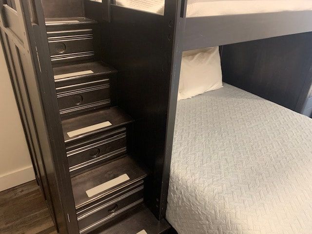 A bunk bed with stairs leading up to it.