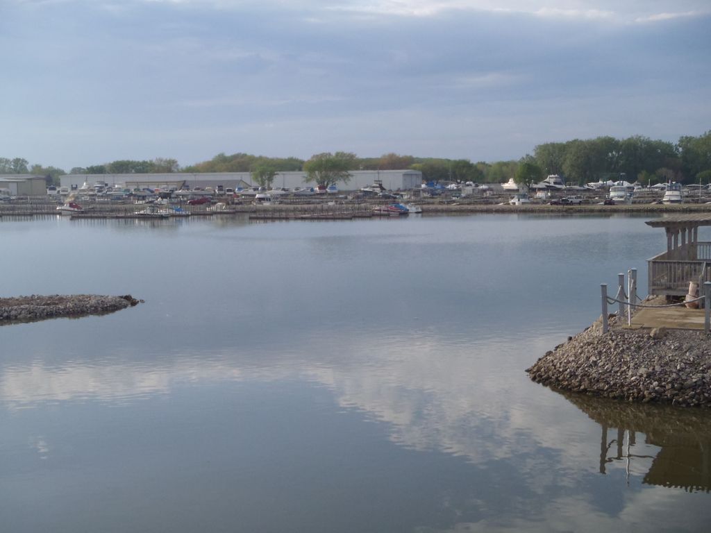 A large body of water with a dock in the middle of it