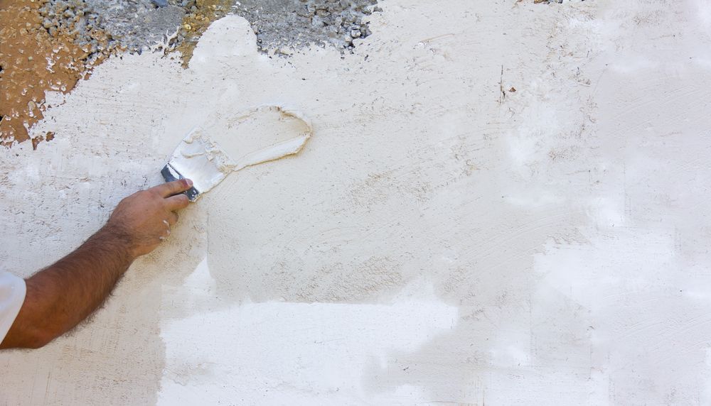 A Man Working on A Textured White Rough Walls — Rendering By Yilmaz P/L In Wollongong, NSW