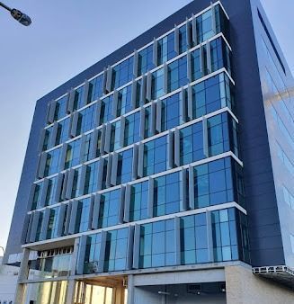 A Large Building With A Lot Of Windows And A Street Light In Front Of It — Rendering By Yilmaz P/L In Wollongong, NSW