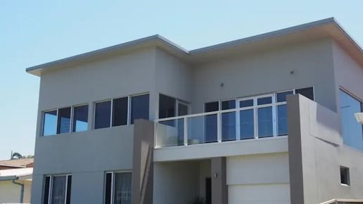 A Large White House With A Balcony And Lots Of Windows — Rendering By Yilmaz P/L In Wollongong, NSW
