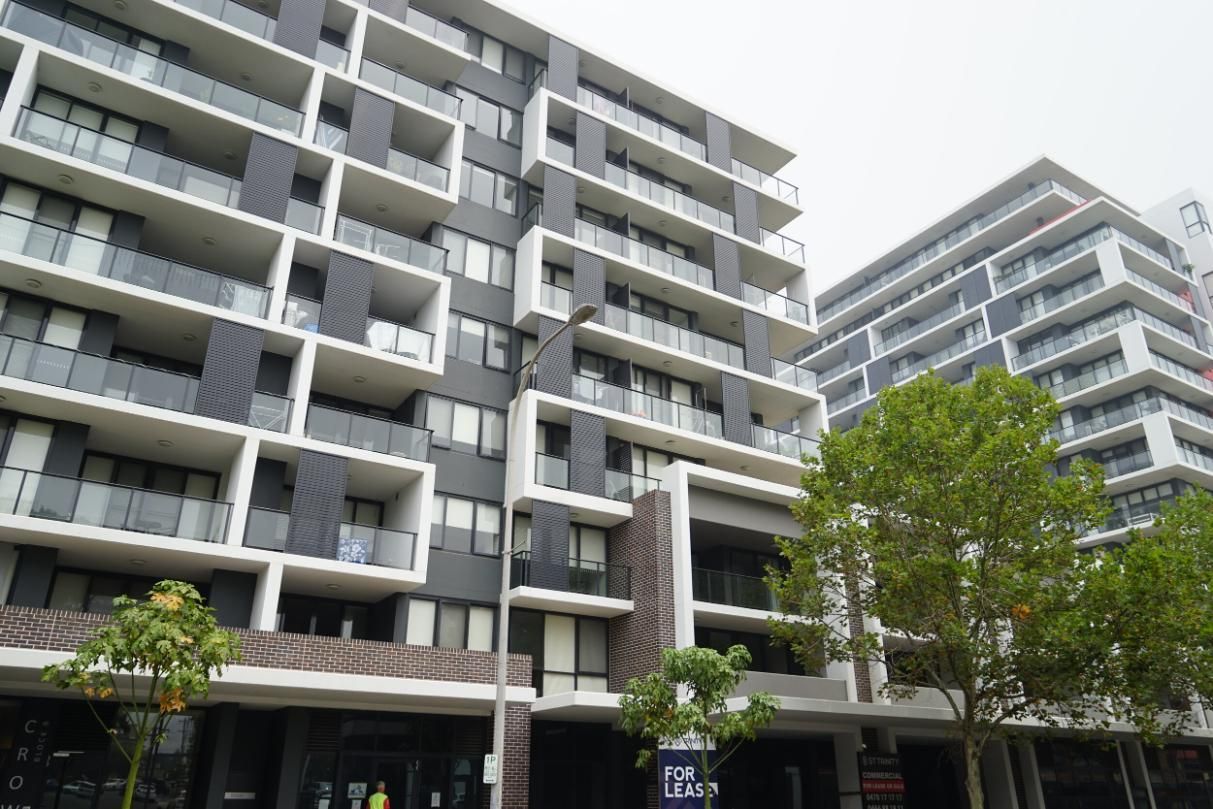 A Large Apartment Building With A Lot Of Balconies And Trees In Front Of It — Rendering By Yilmaz P/L In Wollongong, NSW