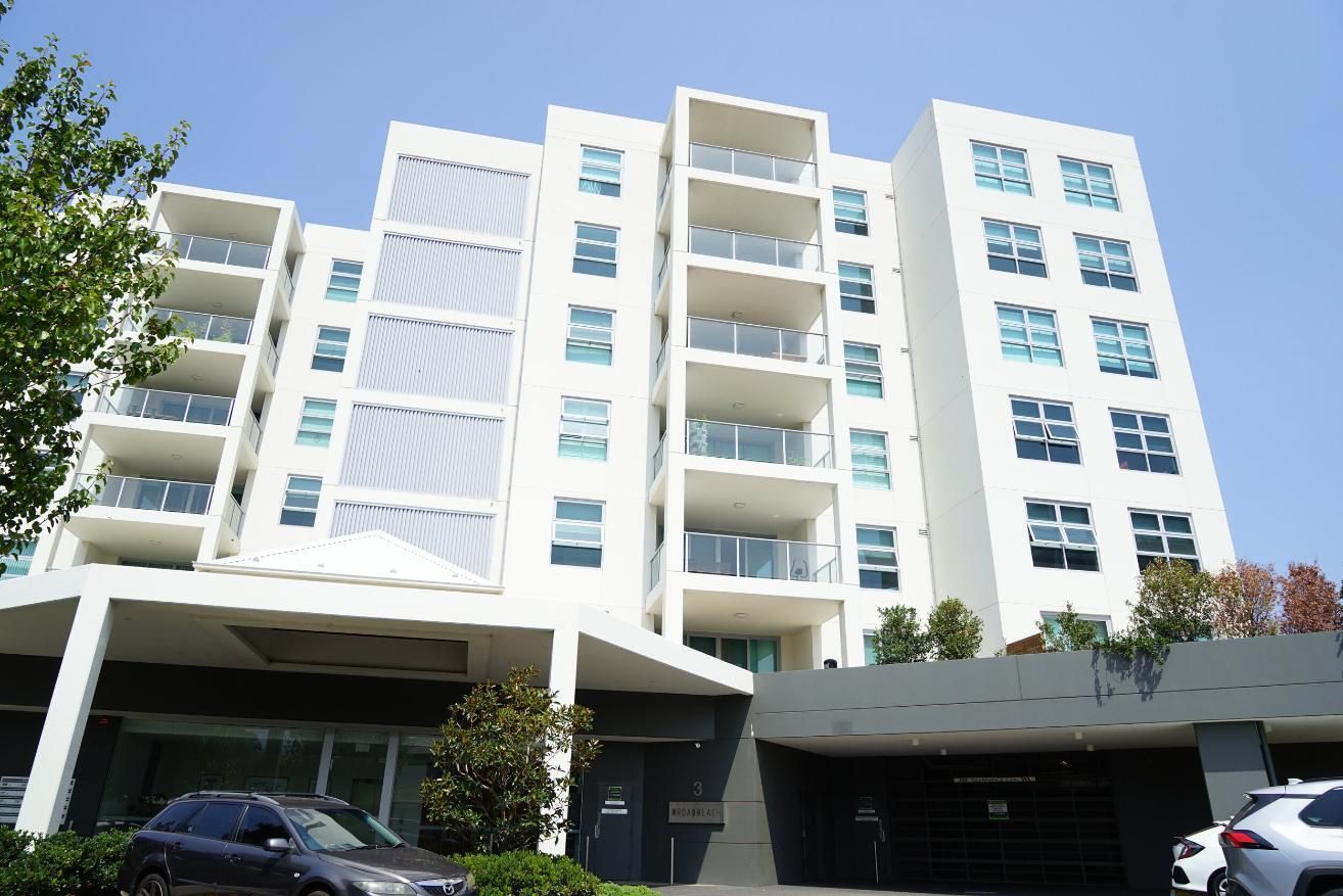 A Car Is Parked In Front Of A Large Apartment Building — Rendering By Yilmaz P/L In Shellharbour, NSW