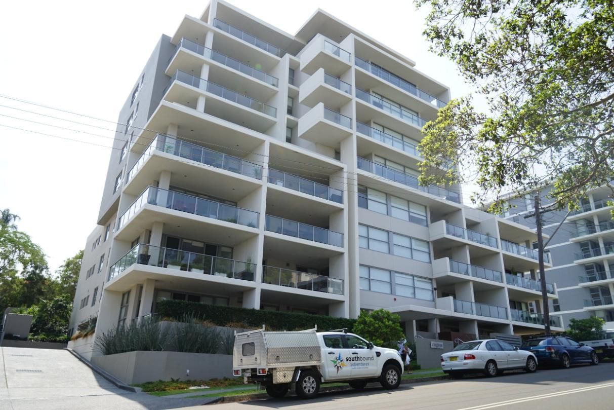 A White Truck Is Parked In Front Of A Large Apartment Building — Rendering By Yilmaz P/L In Wollongong, NSW