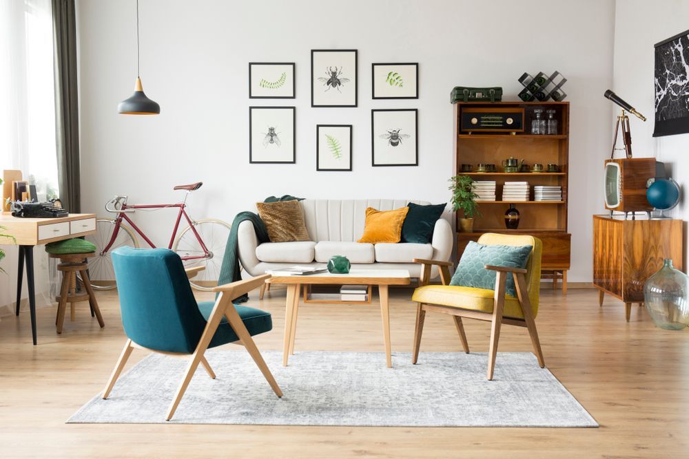 A Living Room With a Couch, Chairs, a Table and a Bicycle — Suncoast Kitchens In Maroochydore, QLD