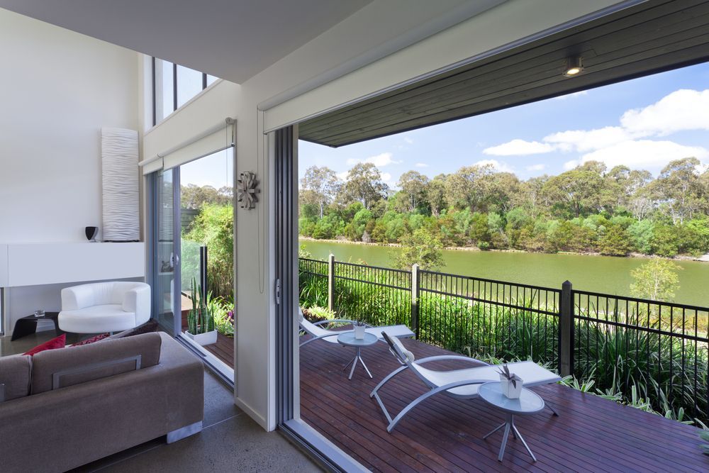 A Living Room With a View of a Lake and a Deck — Suncoast Kitchens In Bli Bli, QLD
