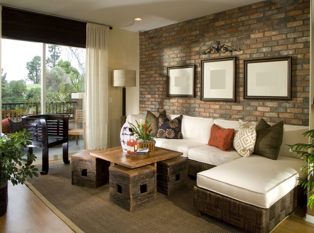 A Living Room With a Brick Wall and a Couch — Suncoast Kitchens In Caboolture, QLD