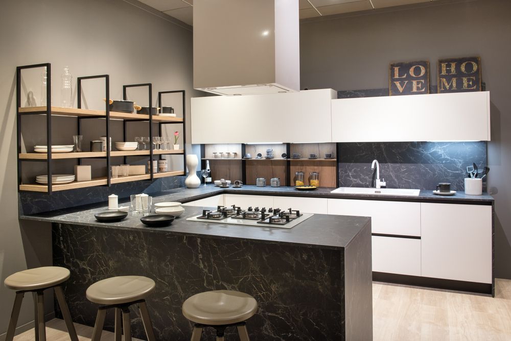 A Kitchen With White Cabinets and Black Counter Tops — Suncoast Kitchens In Kunda Park, QLD
