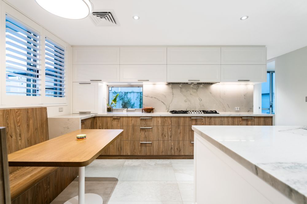 A Kitchen With Wooden Cabinets and White Counter Tops — Suncoast Kitchens In Kunda Park, QLD