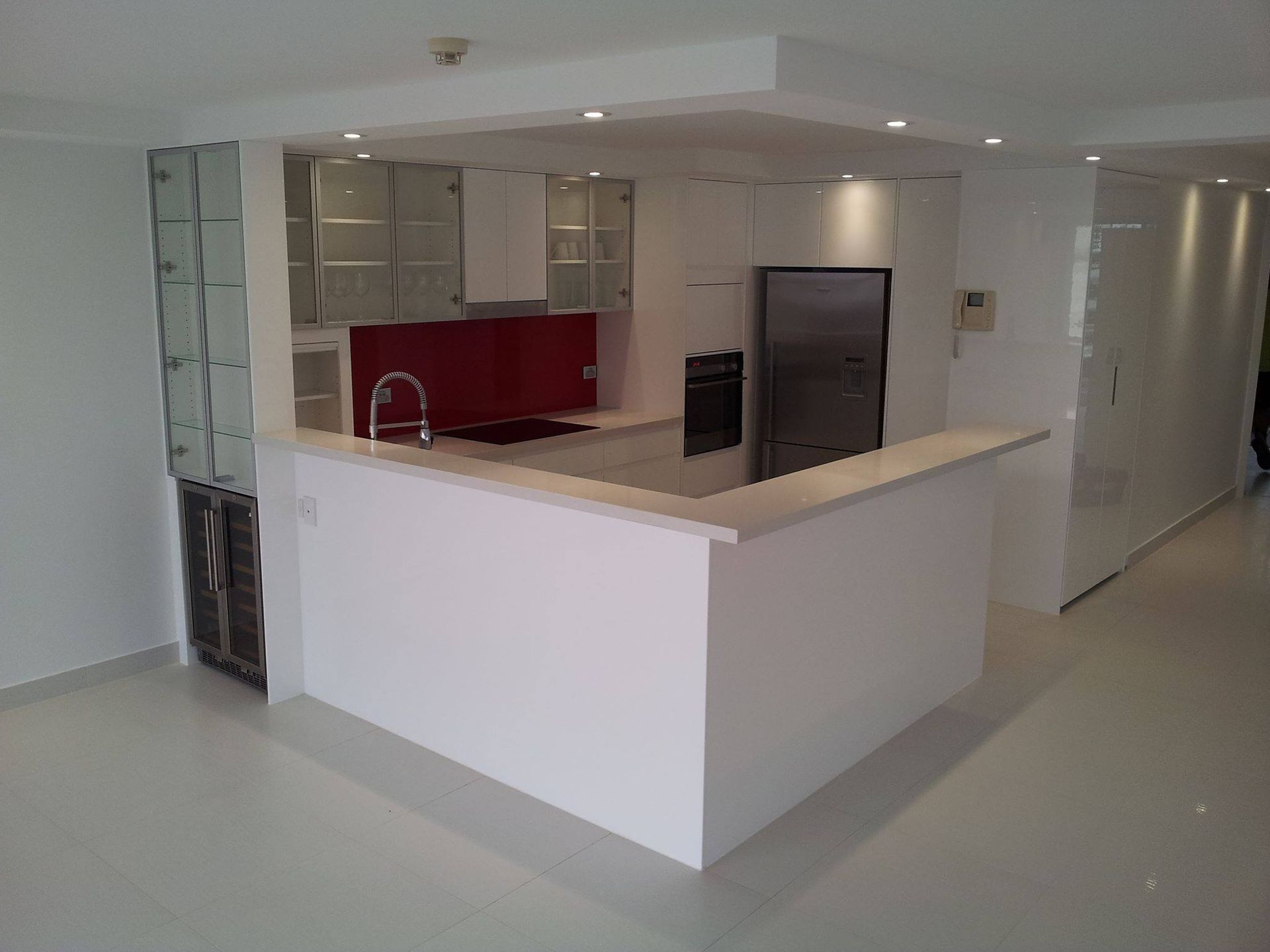 A Kitchen With White Cabinets and a Stainless Steel Refrigerator — Suncoast Kitchens In Gympie, QLD