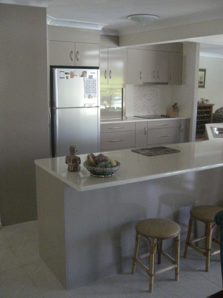 A Kitchen With a Stainless Steel Refrigerator — Suncoast Kitchens In Caloundra, QLD